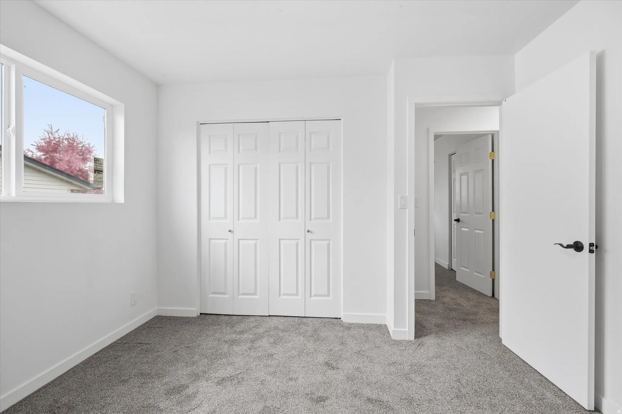 Unfurnished bedroom featuring light colored carpet and a closet