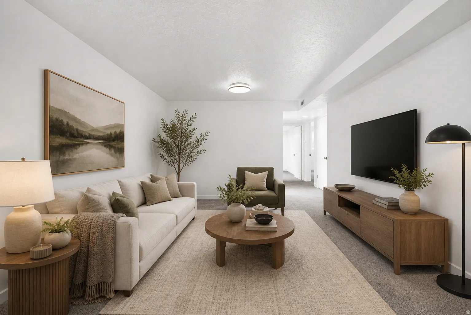 Spacious living area featuring neutral-toned walls, recessed lighting, and soft gray carpeting