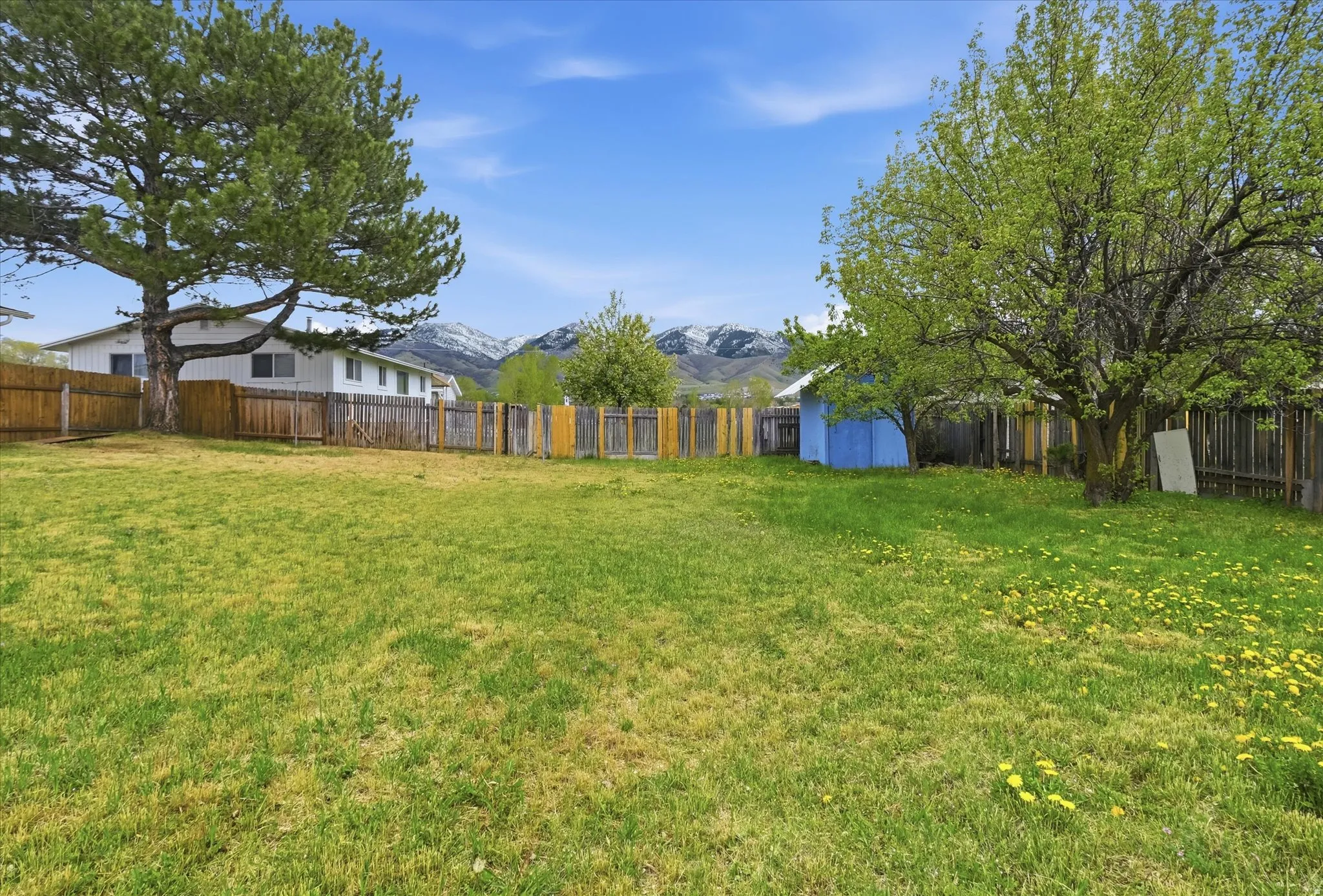 Fenced backyard with a mountain view