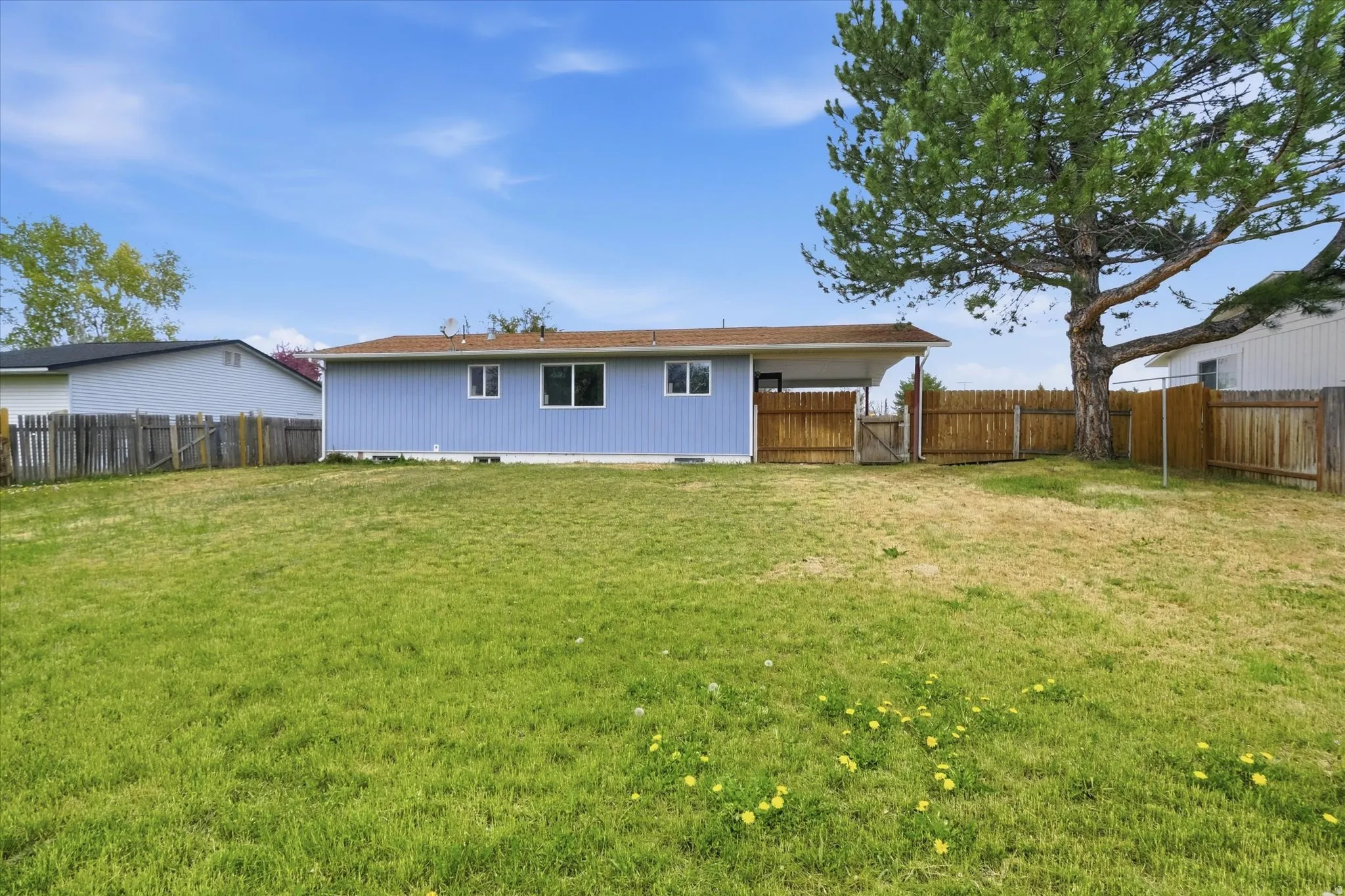 Back of house featuring crawl space and a fenced backyard