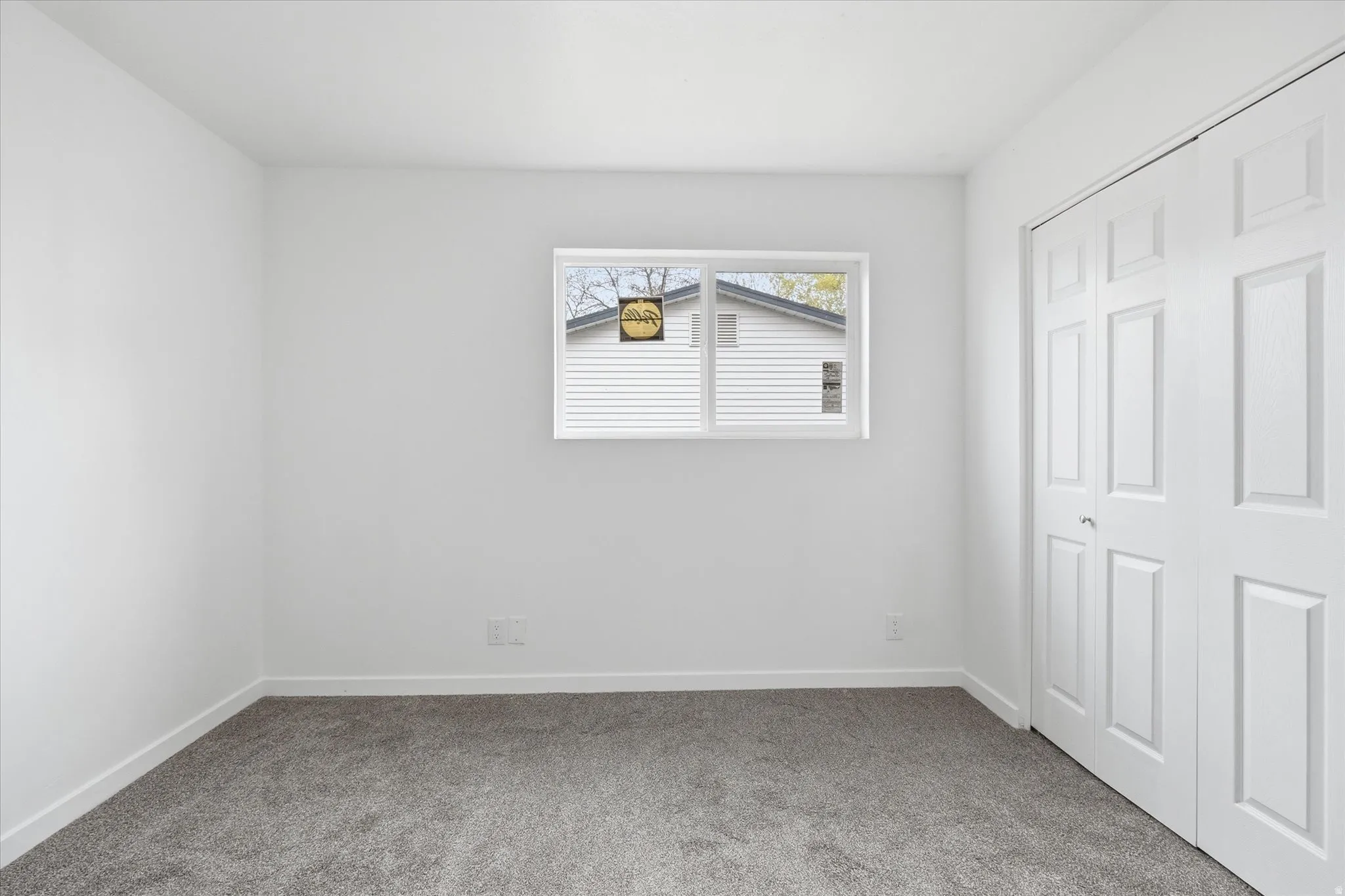 Unfurnished bedroom featuring light colored carpet and a closet