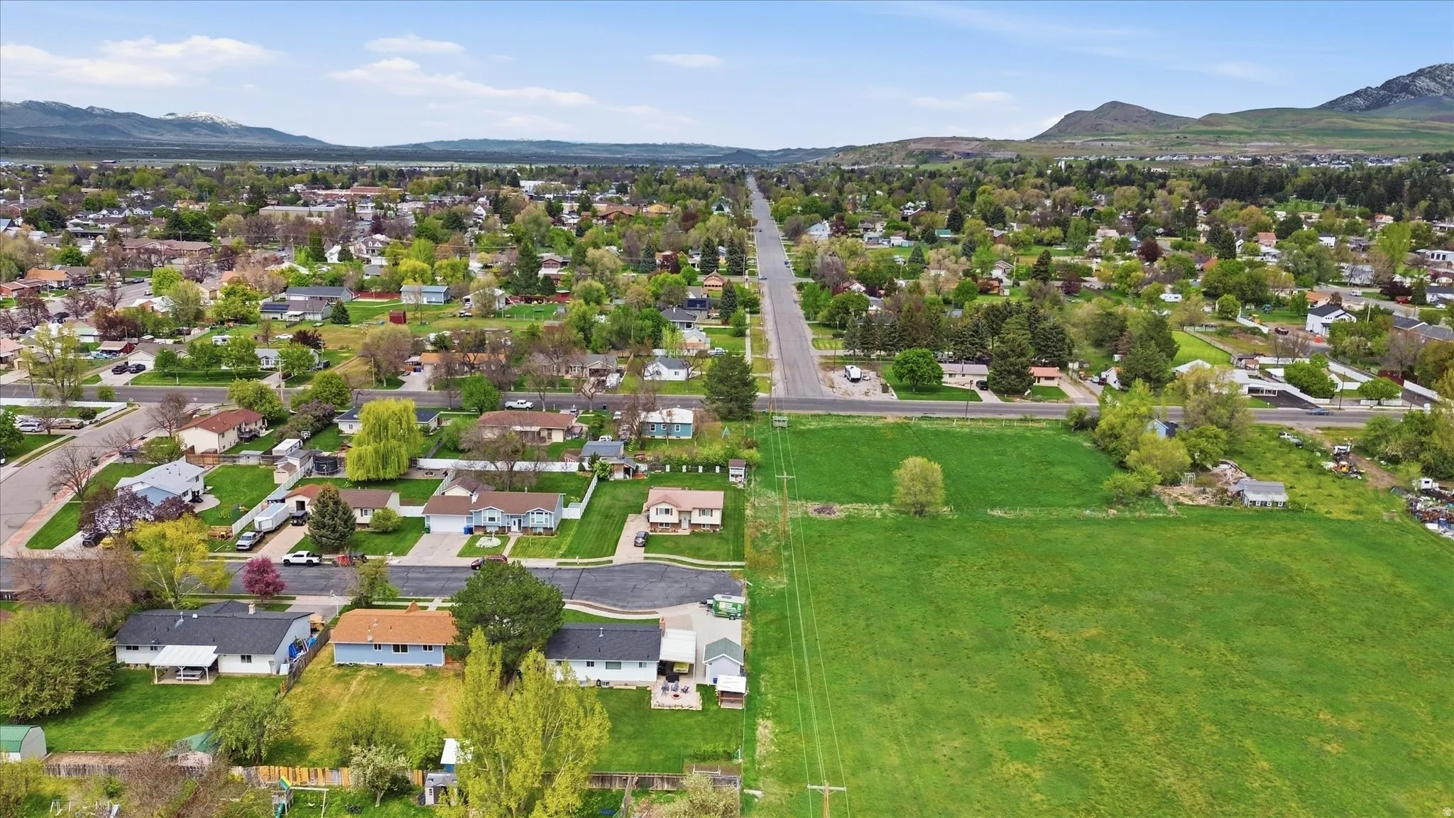 Aerial perspective of suburban area featuring a mountain backdrop