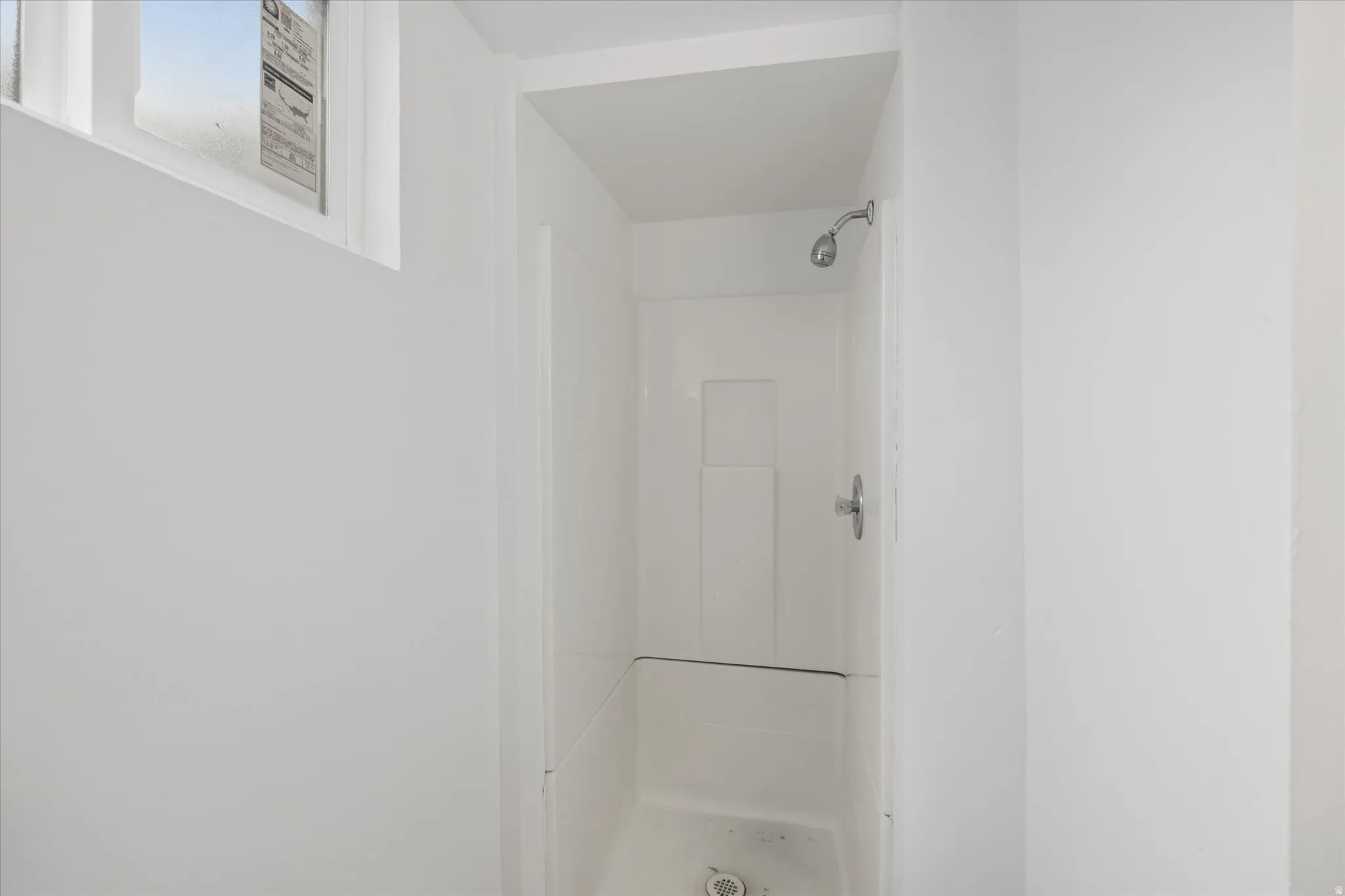 Full bathroom featuring a stall shower
