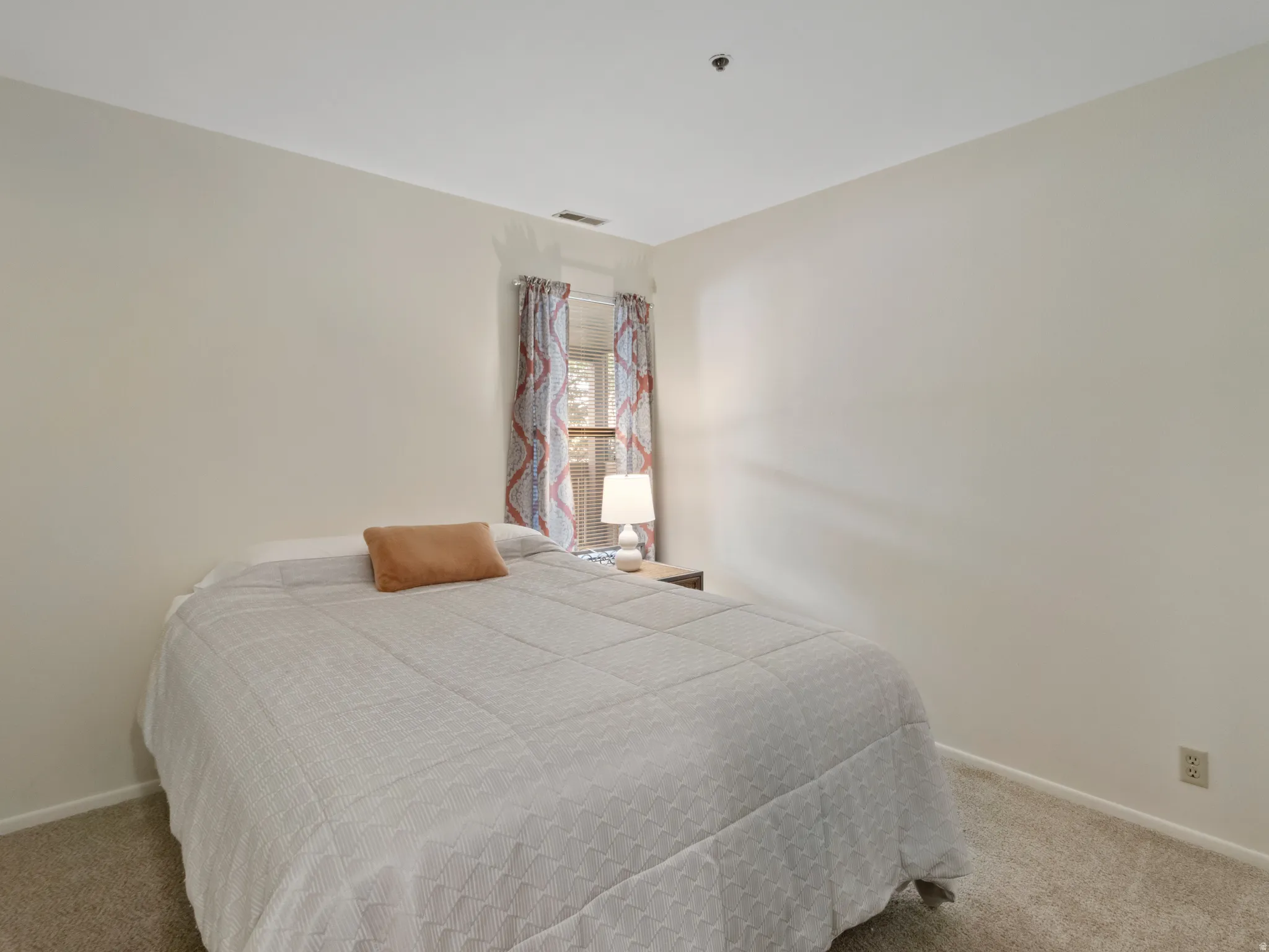 Bedroom with light carpet