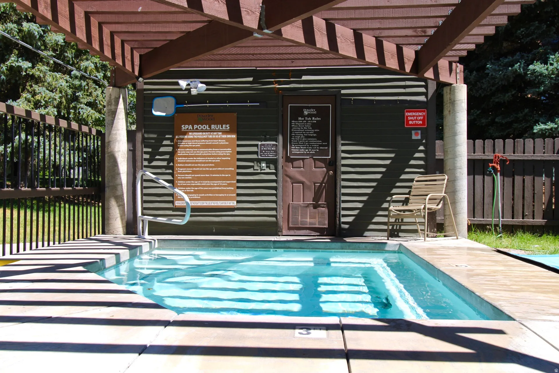 Outdoor spa with integrated steps and a surrounding concrete deck