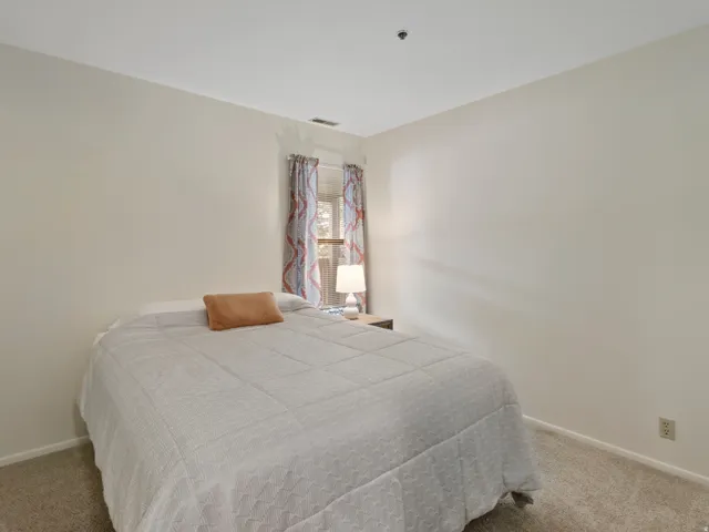 Bedroom with light carpet