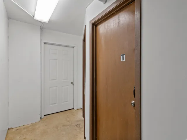 Corridor featuring concrete flooring