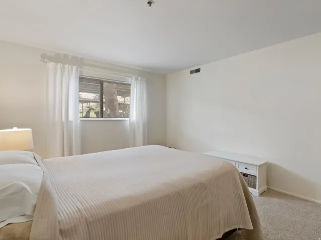 Bedroom featuring carpet flooring and baseboards