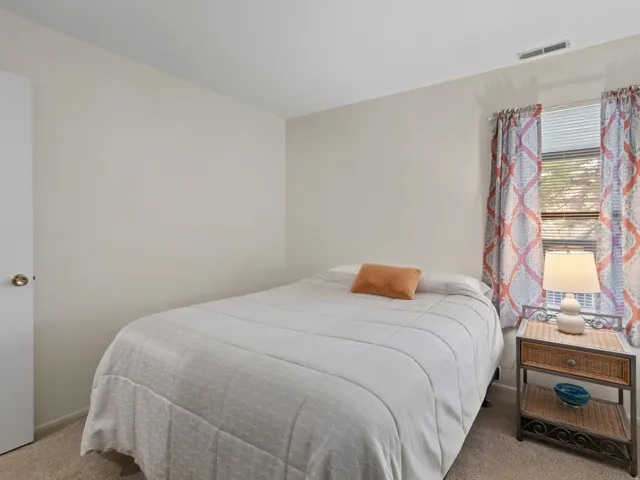 Bedroom with light colored carpet