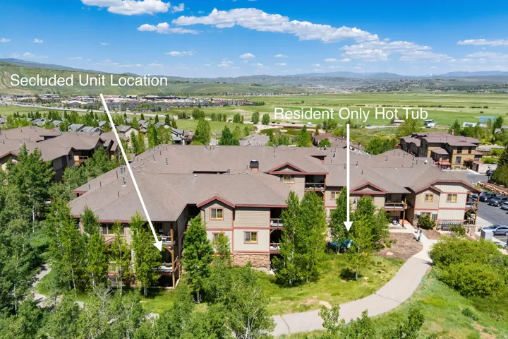 Aerial perspective of suburban area featuring mountains and property parcel outlined