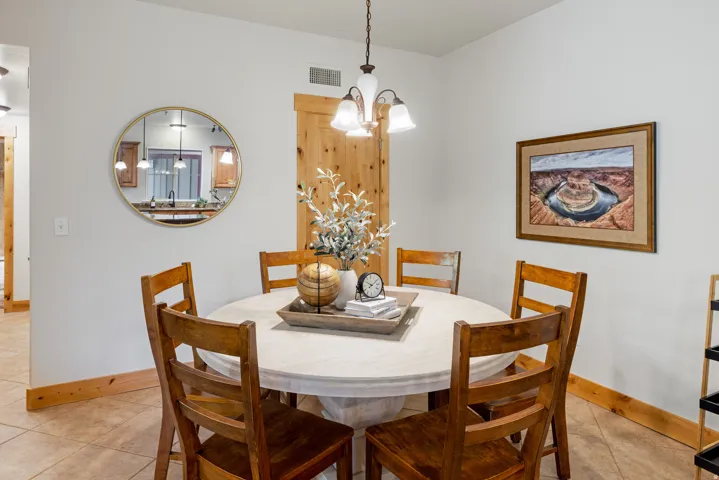 Dining room with light tile patterned floors and a chandelier