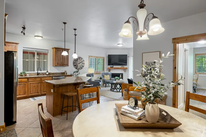 Dining space with a fireplace, suspended lighting, and light tile patterned floors