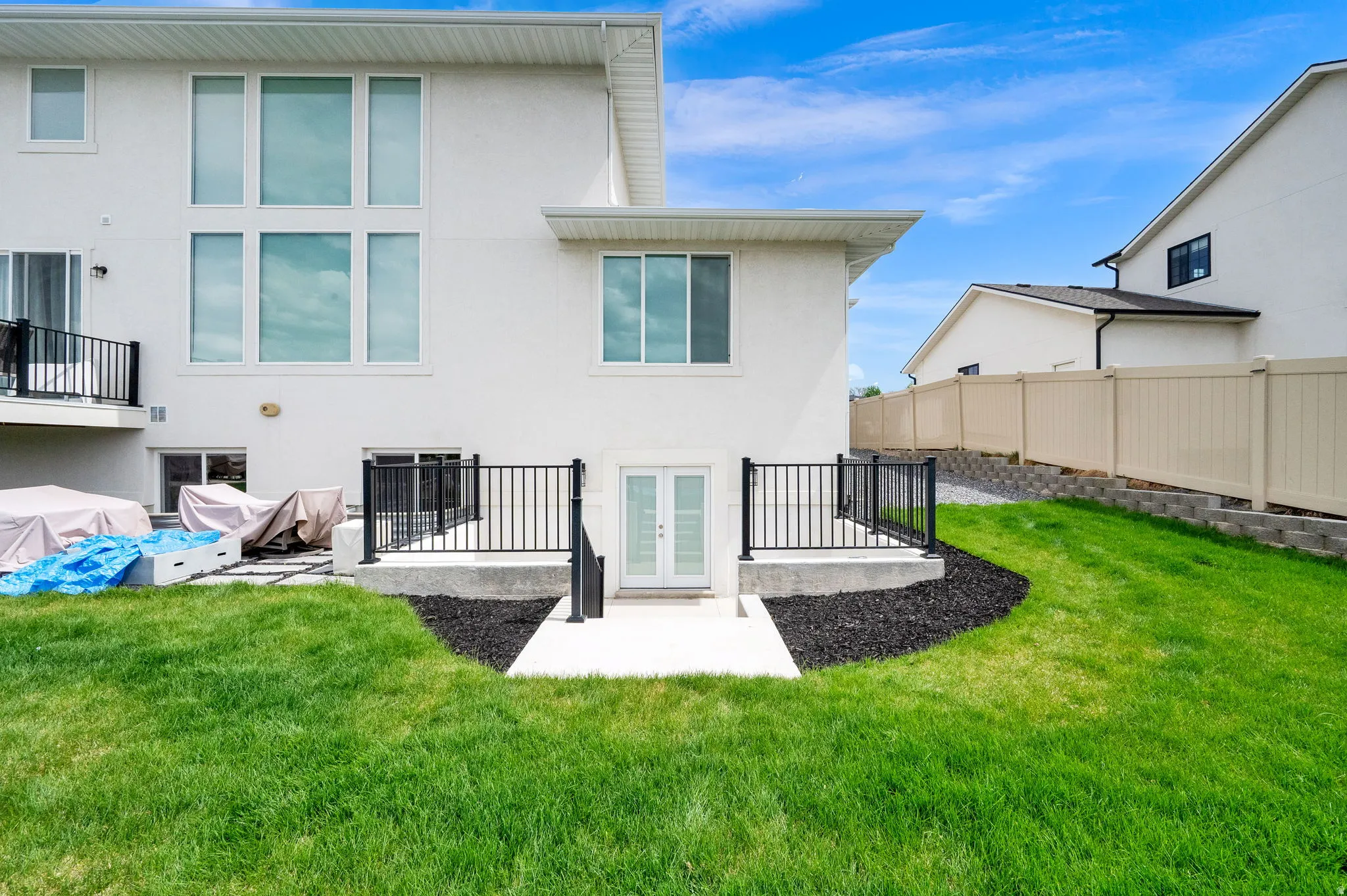 Back of house with a patio area, stucco siding, and french doors