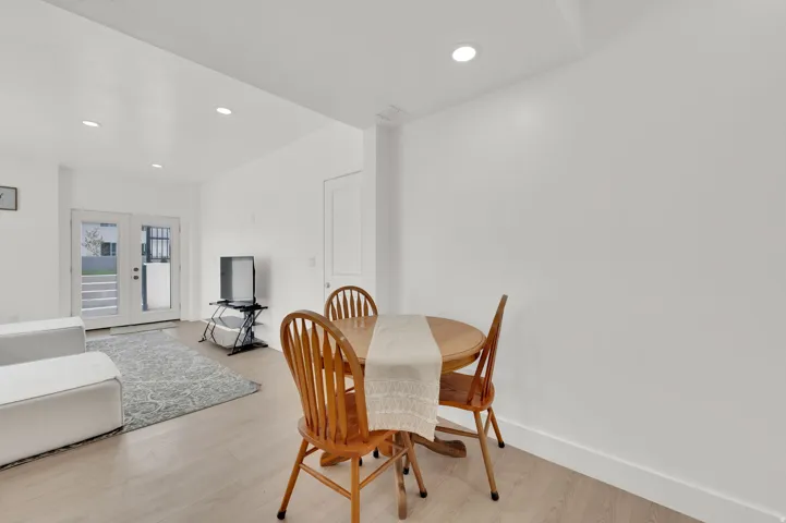 Dining room with french doors, recessed lighting, and light wood finished floors