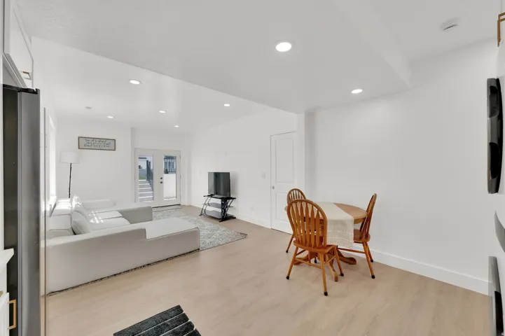 Dining area with light wood-style floors and recessed lighting