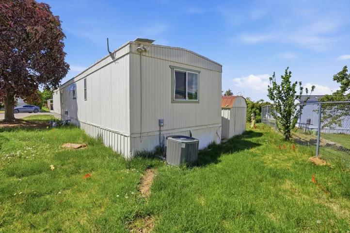 View of side of home featuring a central AC unit