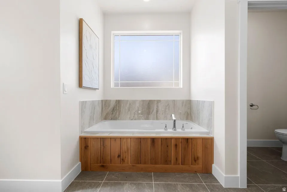 Bathroom featuring a bath and tile patterned floors