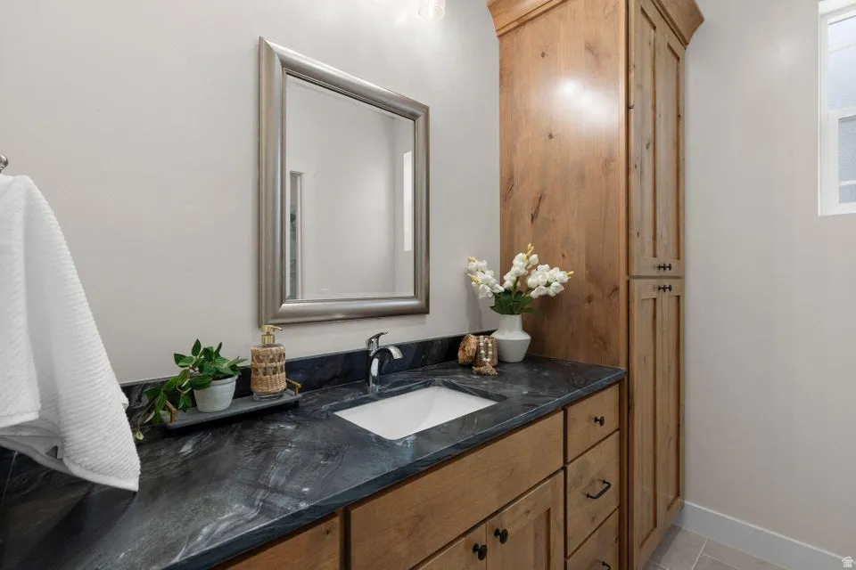 Bathroom with vanity and baseboards