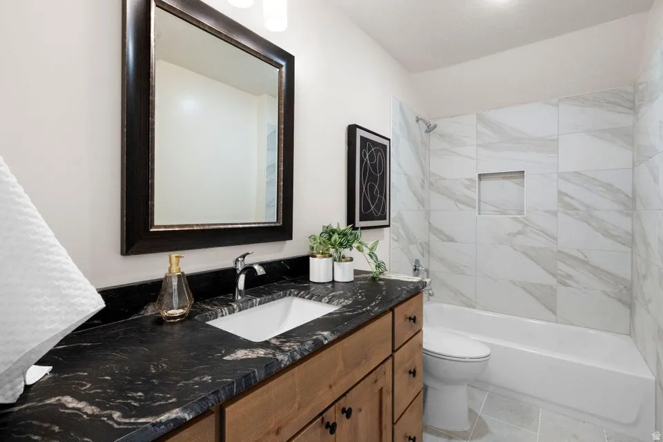 Full bathroom with vanity and bathing tub / shower combination