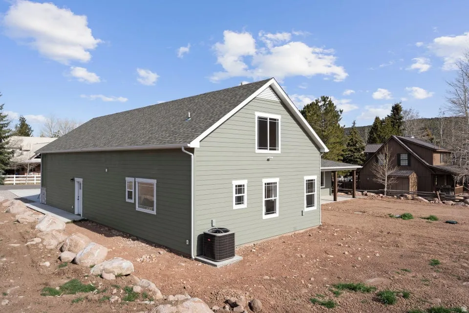 Rear view of house with a shingled roof