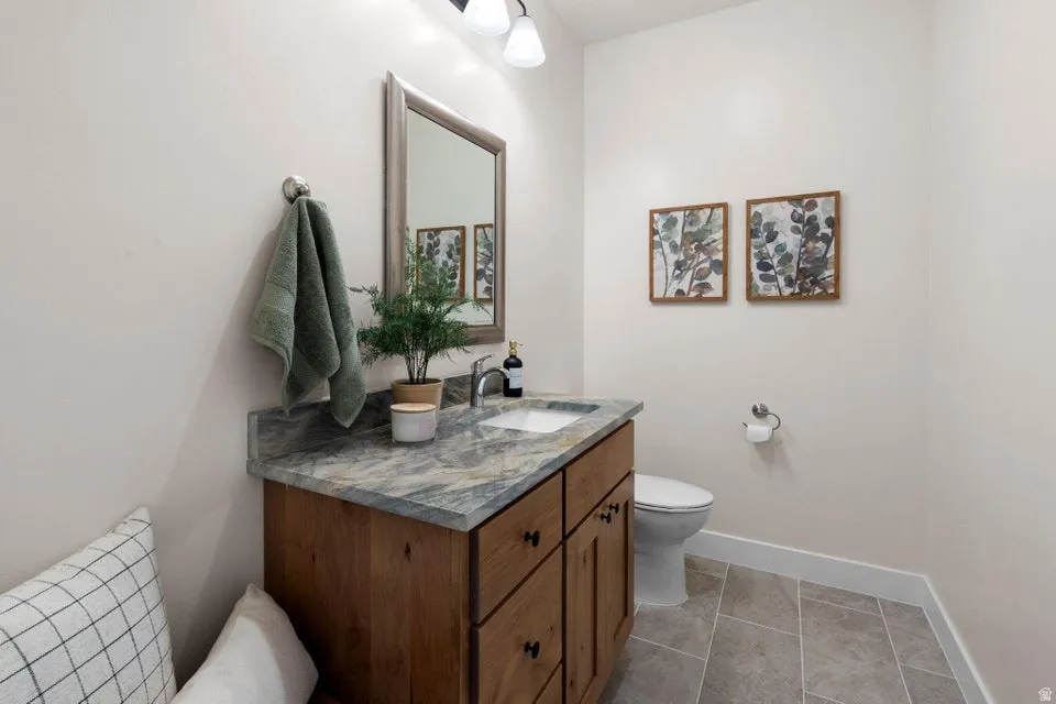 Half bath featuring vanity and light tile patterned floors