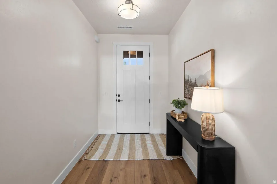 Foyer featuring light wood-style floors and baseboards
