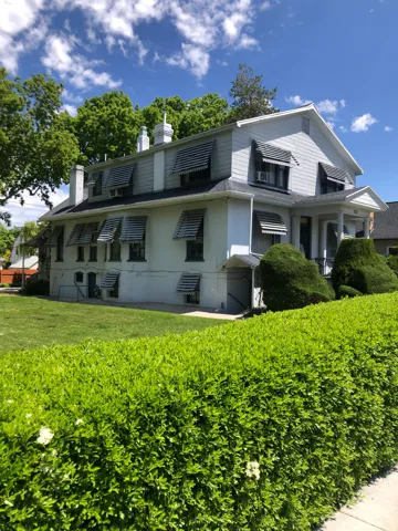 View of front of home with a chimney and a front lawn