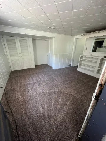 Below grade area featuring dark carpet