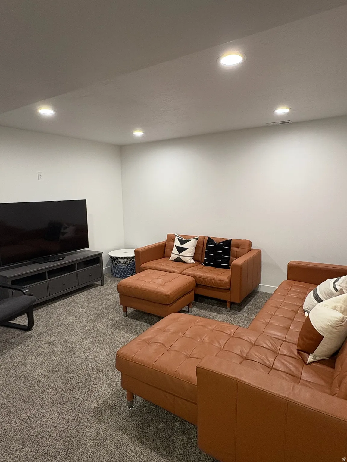 Living room with carpet floors and recessed lighting