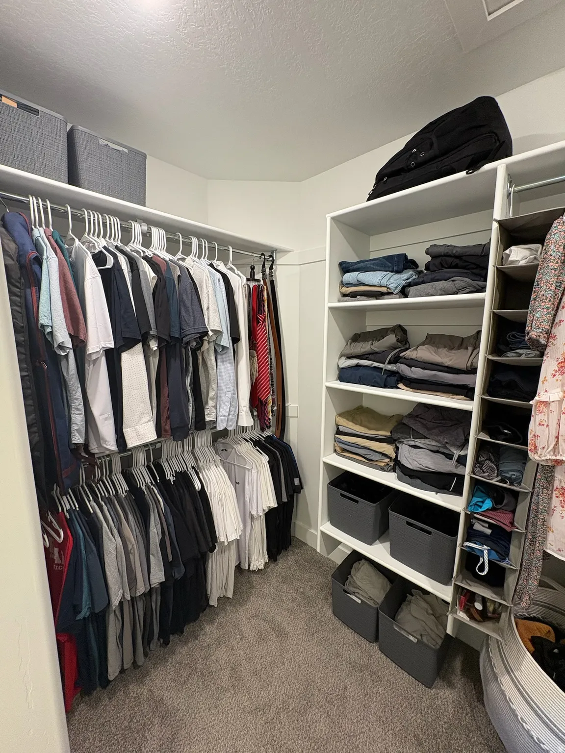 Walk in closet with dark carpet and attic access
