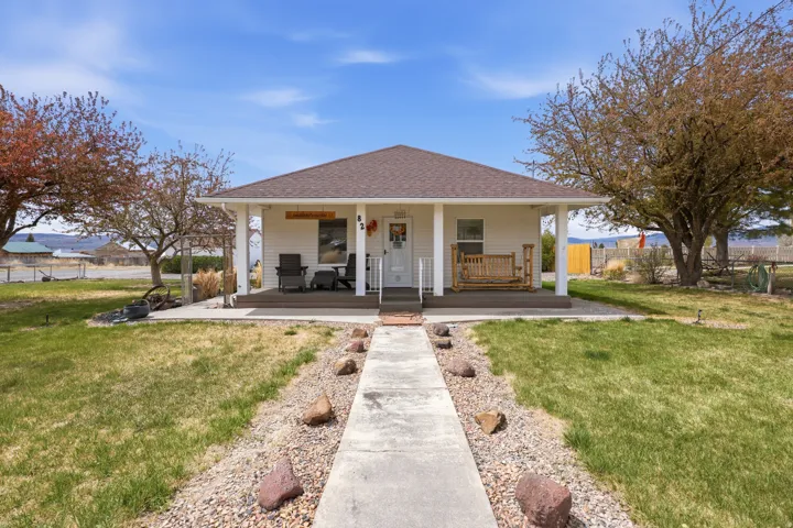 View of front of home featuring a porch and roof with shingles