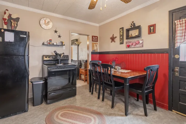 Dining space featuring ceiling fan and ornamental molding