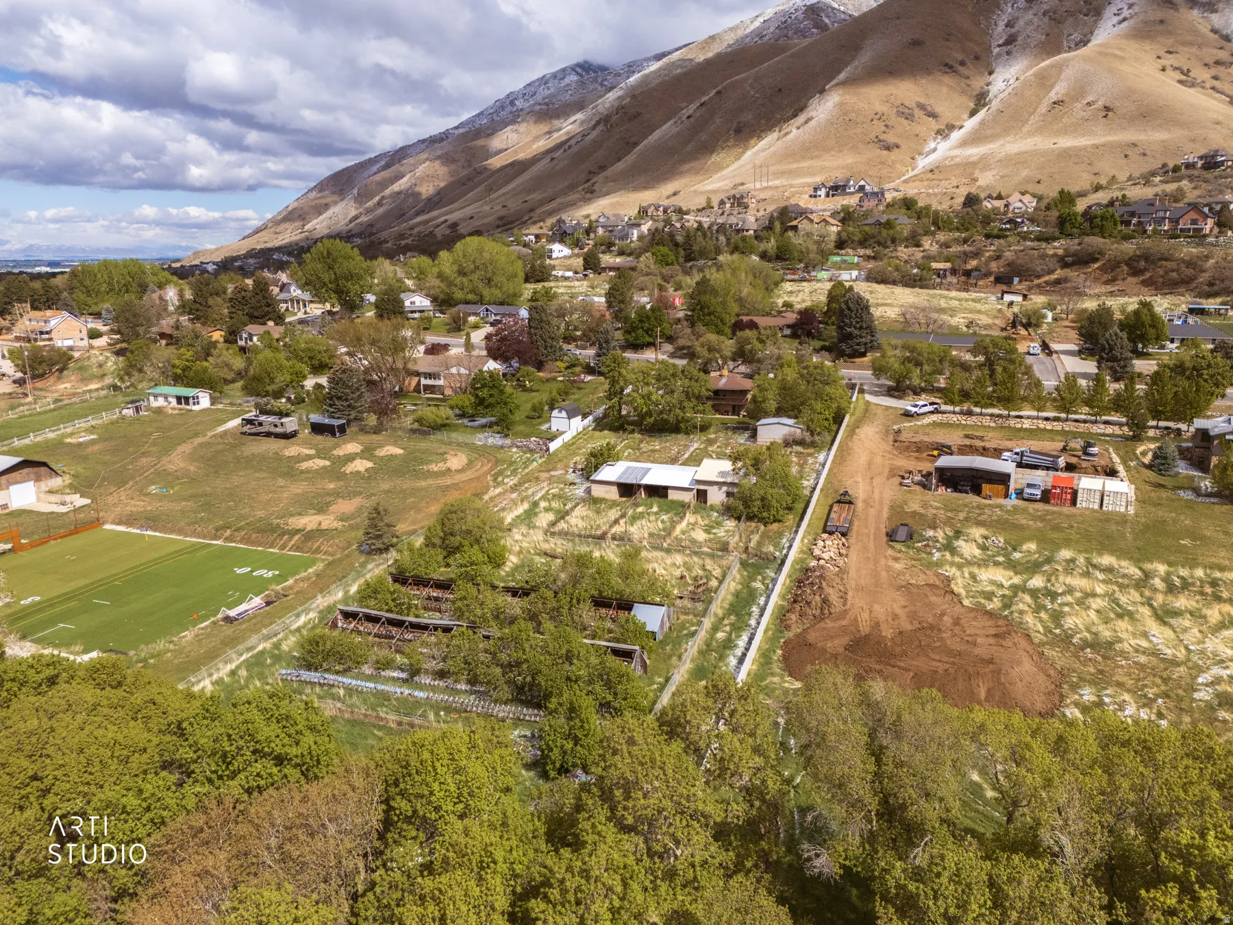 Aerial view of sparsely populated area featuring a mountain backdrop