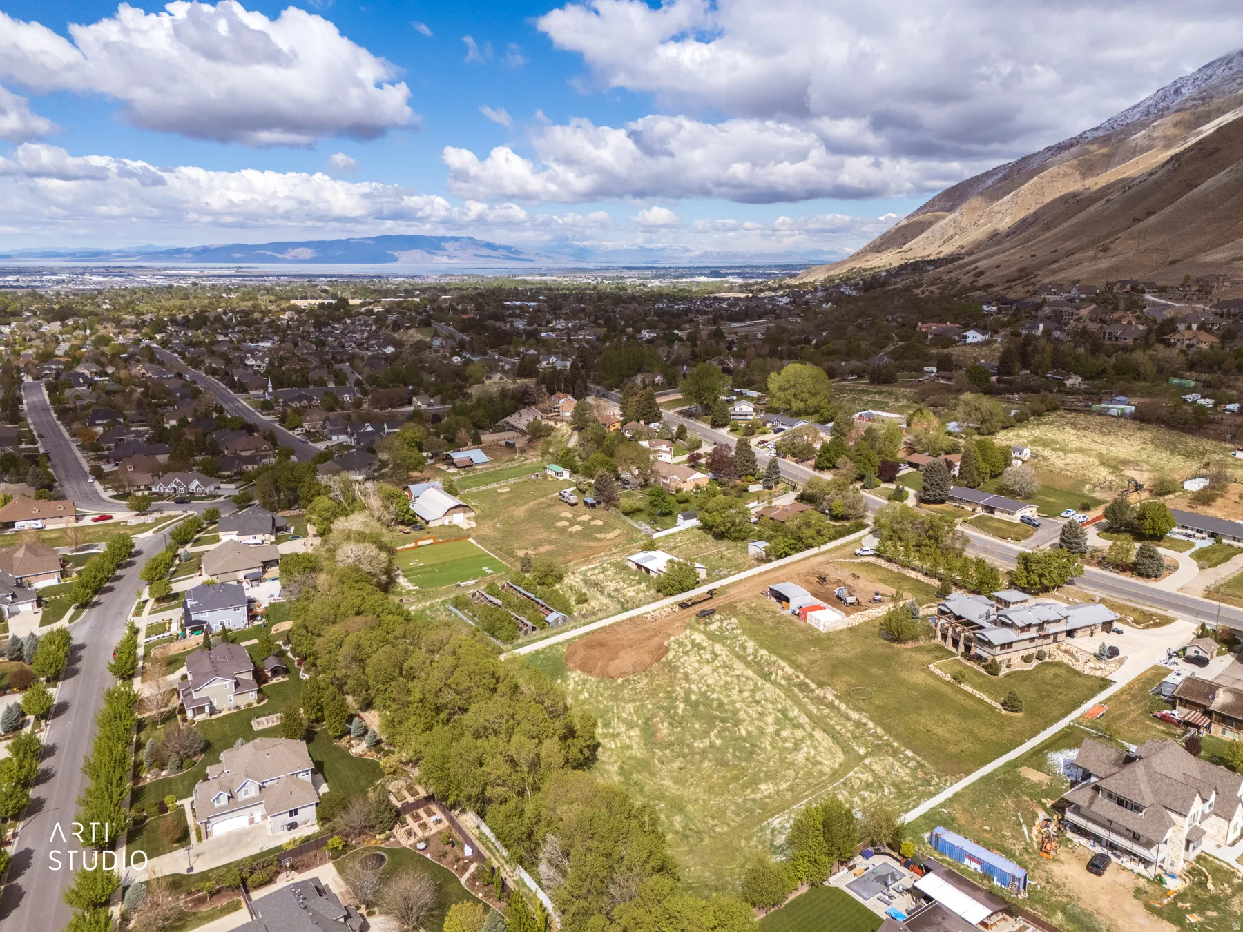 Aerial perspective of suburban area with a mountainous background