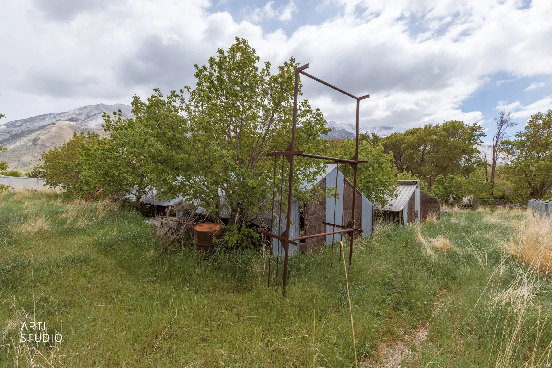 View of side of property featuring an outdoor structure and a mountain view