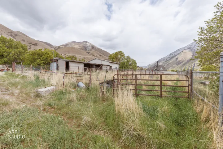 View of yard featuring a mountain view and an outbuilding