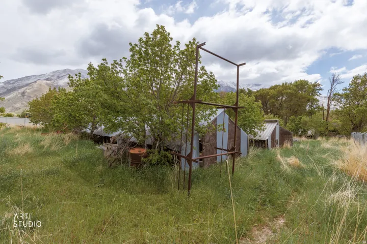 View of side of property featuring an outdoor structure and a mountain view