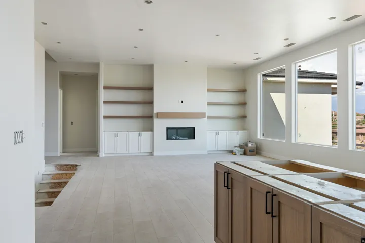 Spacious interior featuring wood-finish flooring, recessed lighting, and large windows