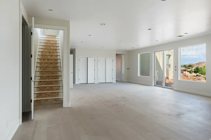 Spacious interior featuring light wood-finish flooring, recessed lighting, and white walls