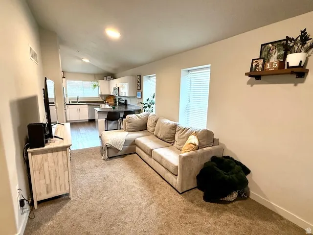 Living room with lofted ceiling and baseboards