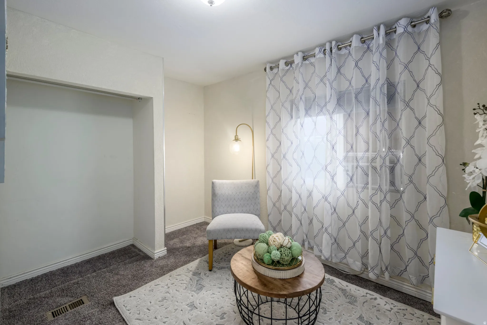 Sitting room with carpet flooring and baseboards