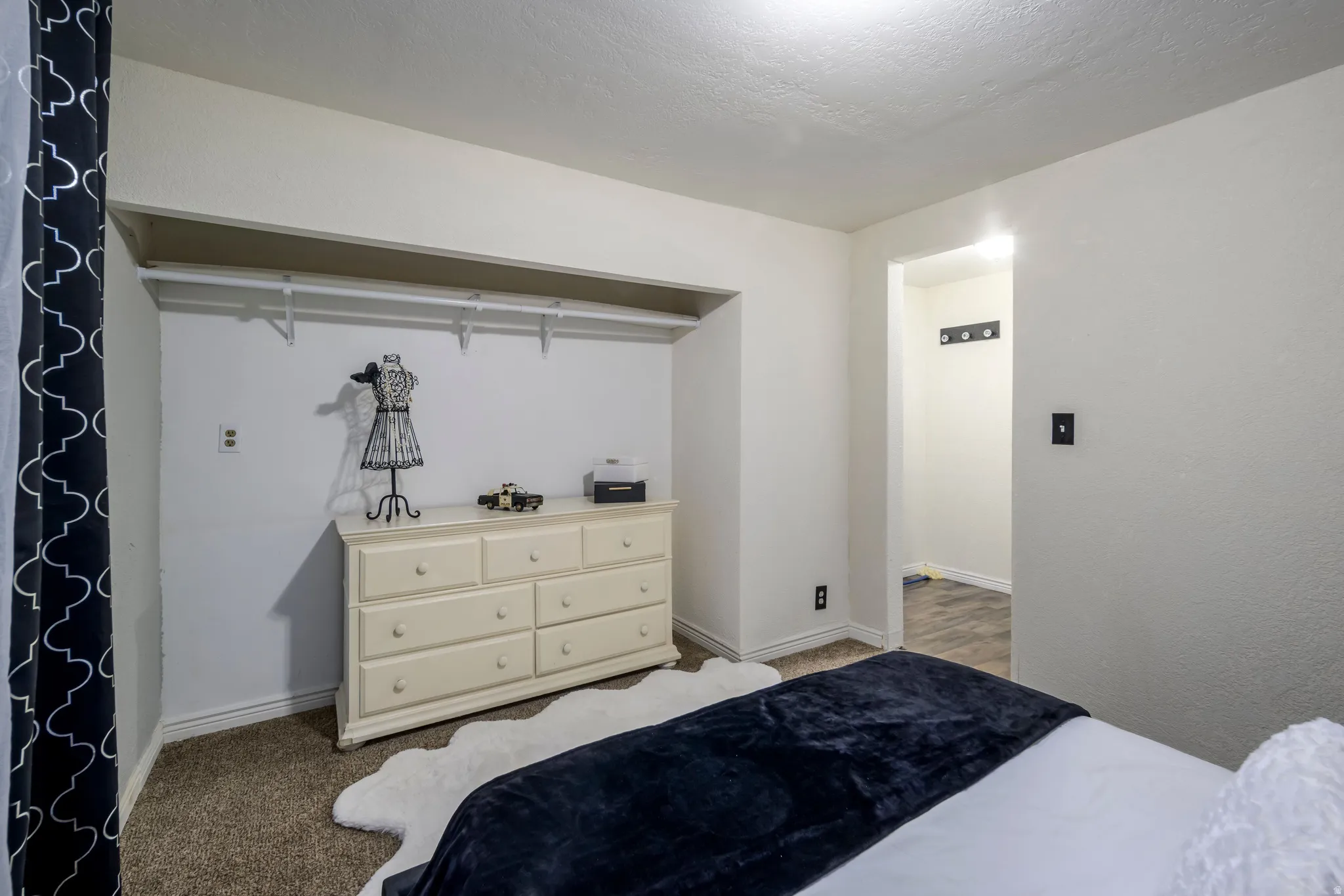 Bedroom with carpet floors and baseboards