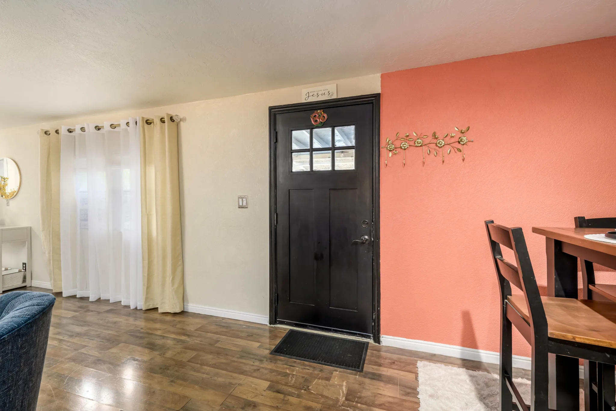 Foyer with dark wood-style flooring and baseboards