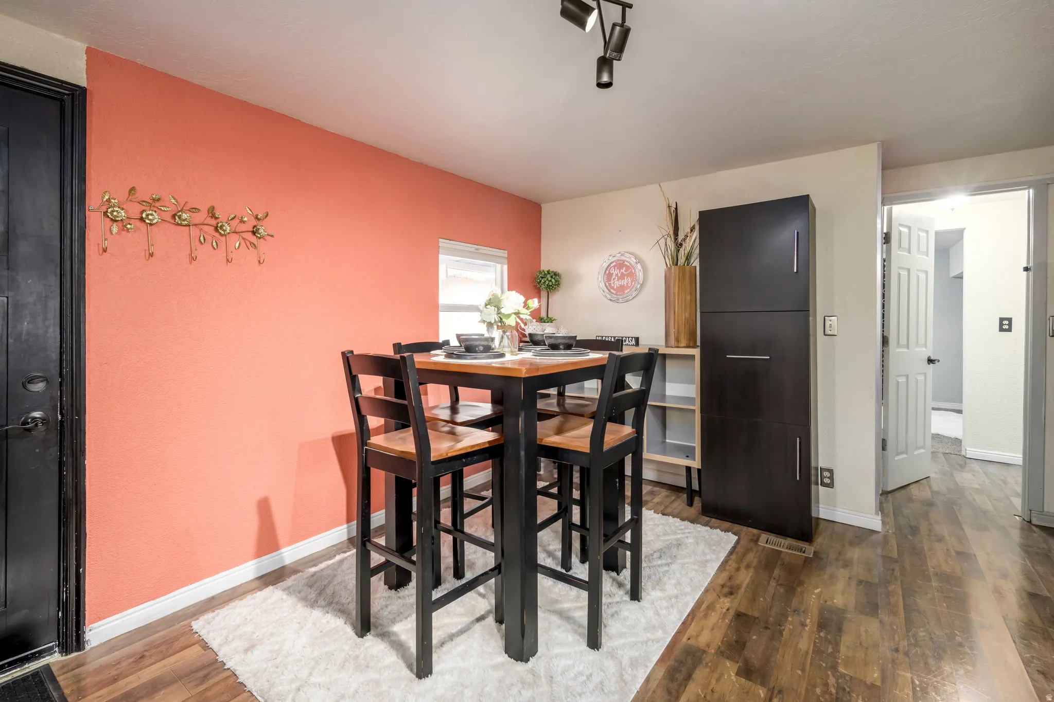 Dining area with hardwood / wood-style floors and baseboards