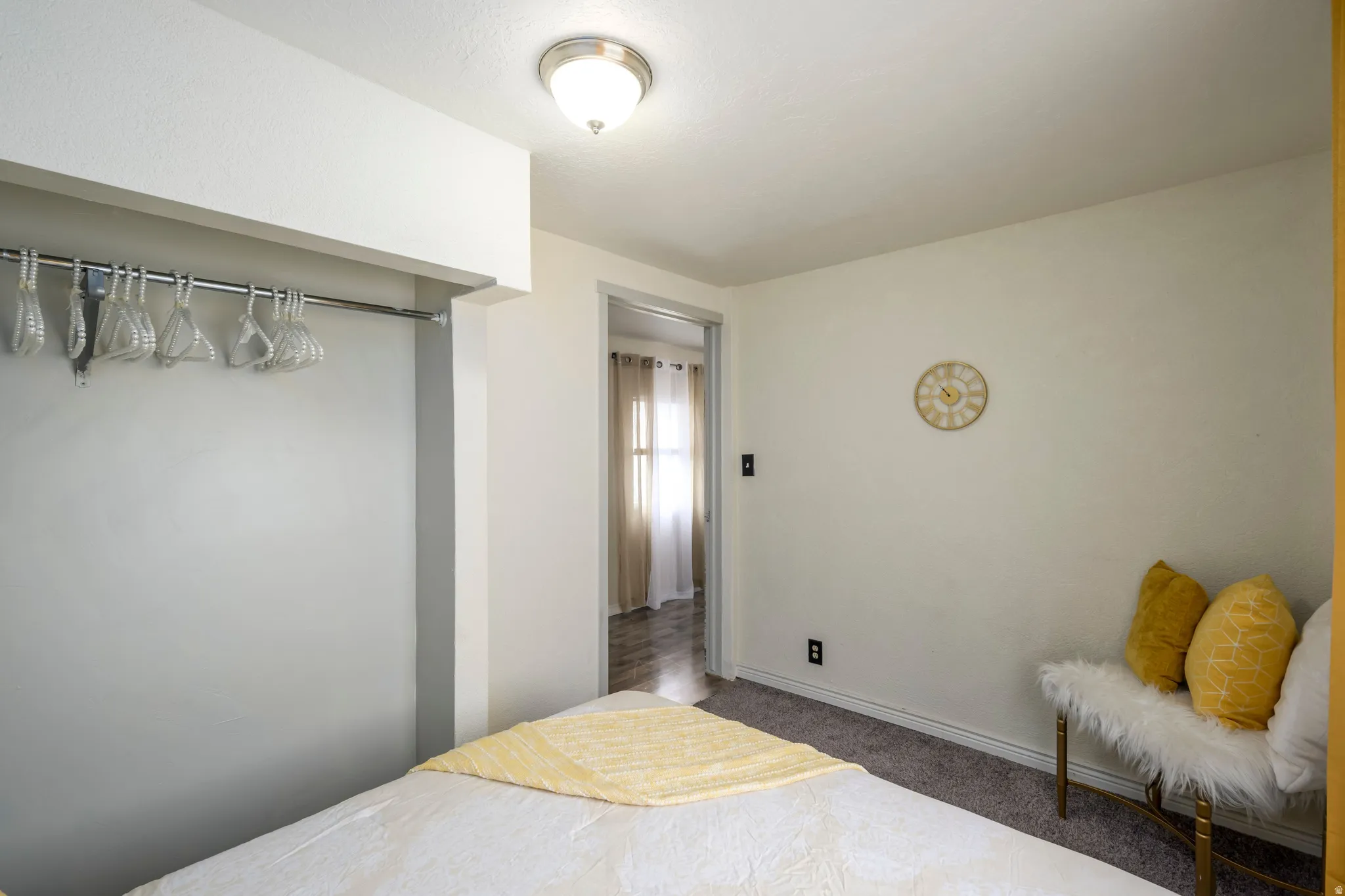 Bedroom with dark carpet and baseboards