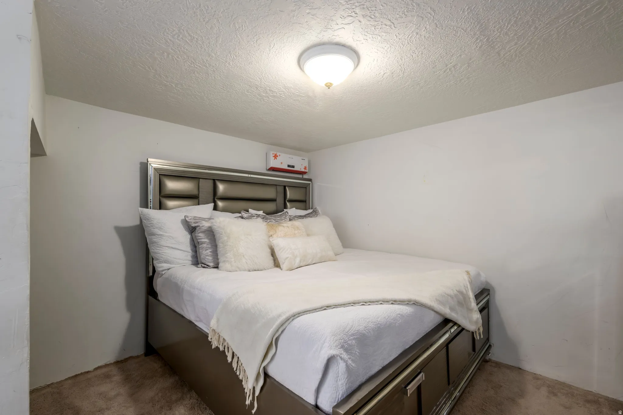 Bedroom with a textured ceiling