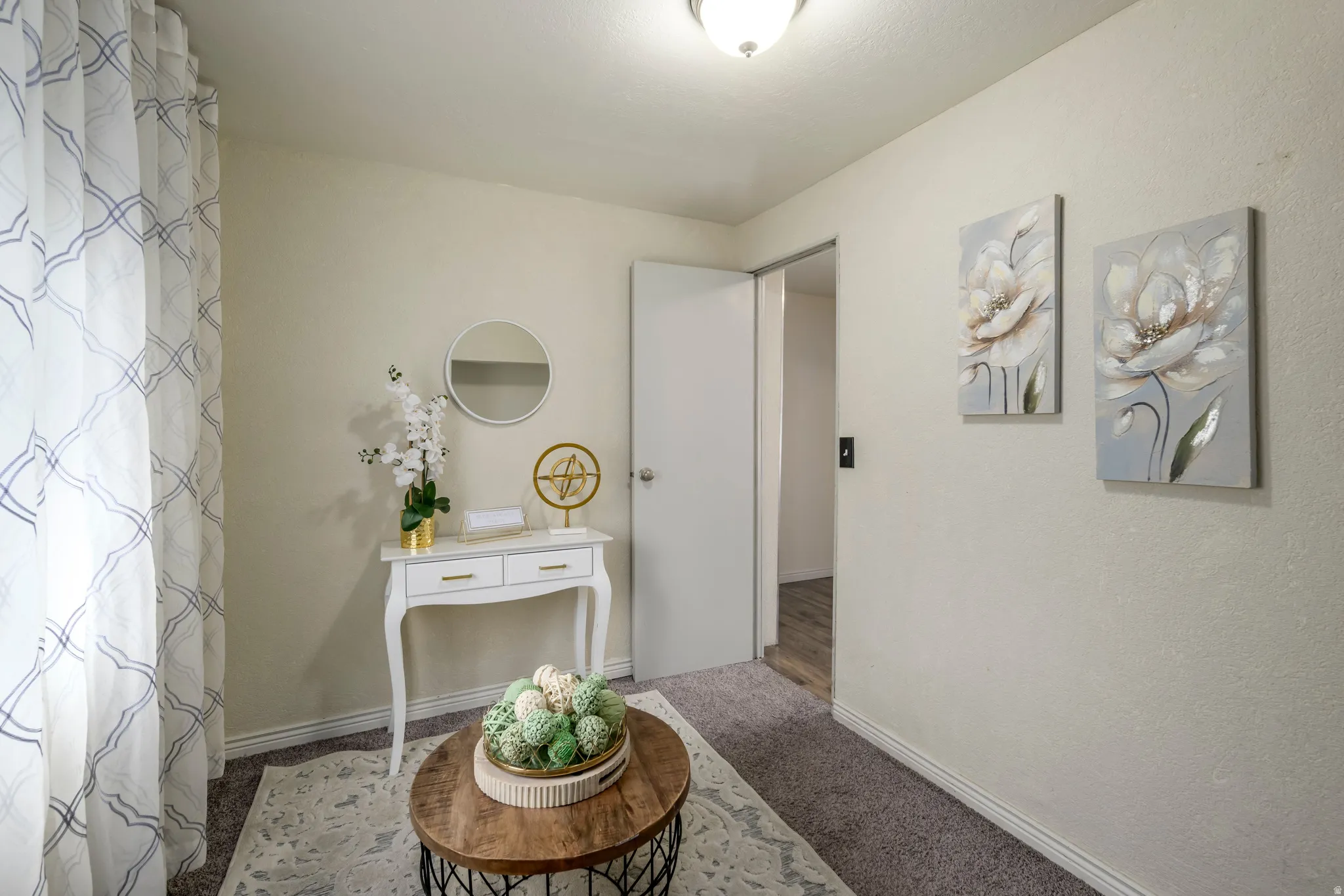 Hallway featuring carpet and a textured wall