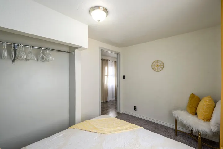 Bedroom with dark carpet and baseboards