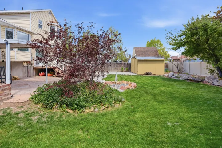 Fenced backyard with a storage unit
