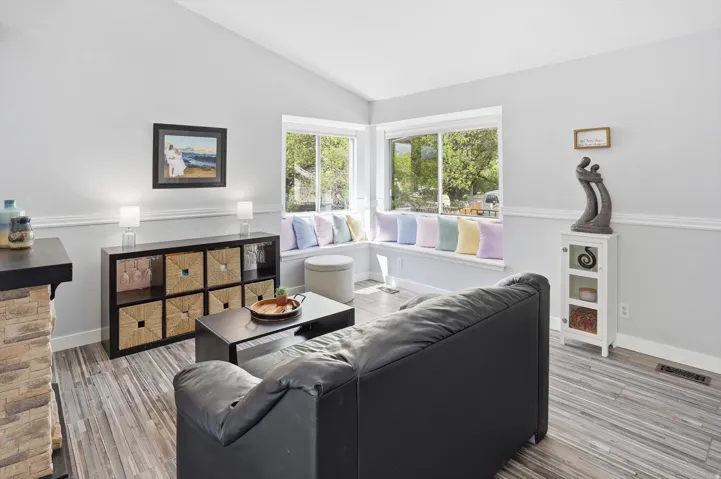 Living area with lofted ceiling and light wood-style flooring